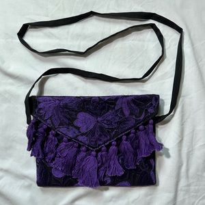 Purple embroidered clutch purse with tassels